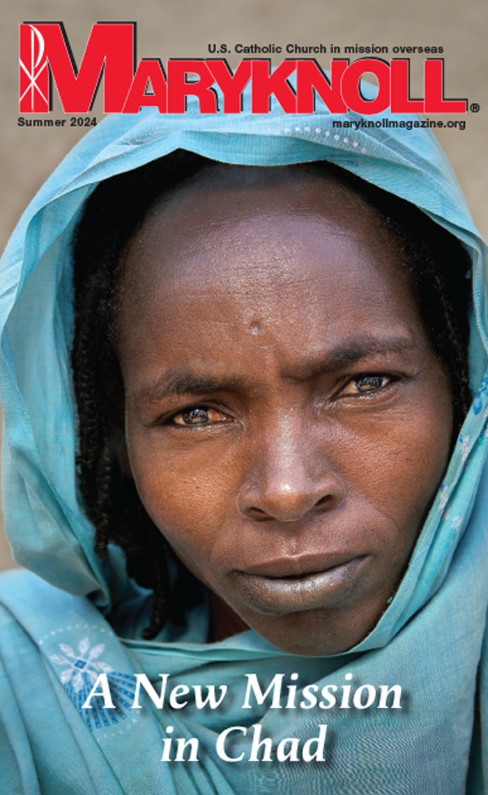 The Summer 2024 cover of Maryknoll Magazine with a picture of a hooded woman looking intensely at the camera