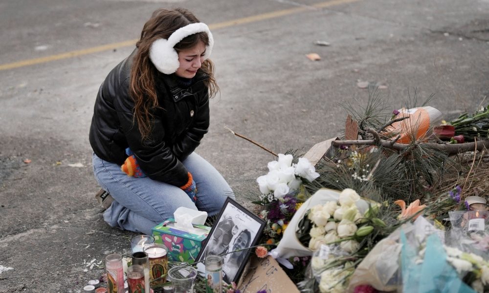 A young woman becomes emotional at a makeshift memorial in Minneapolis Jan. 25, 2026, at the site where a man was fatally shot by federal agents trying to detain him Jan. 24. Archbishop Bernard A. Hebda of St. Paul and Minneapolis, along with other Church leaders, have called for peace amid growing tensions. (OSV News/Tim Evans, Reuters)
