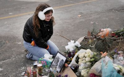 A young woman becomes emotional at a makeshift memorial in Minneapolis Jan. 25, 2026, at the site where a man was fatally shot by federal agents trying to detain him Jan. 24. Archbishop Bernard A. Hebda of St. Paul and Minneapolis, along with other Church leaders, have called for peace amid growing tensions. (OSV News/Tim Evans, Reuters)