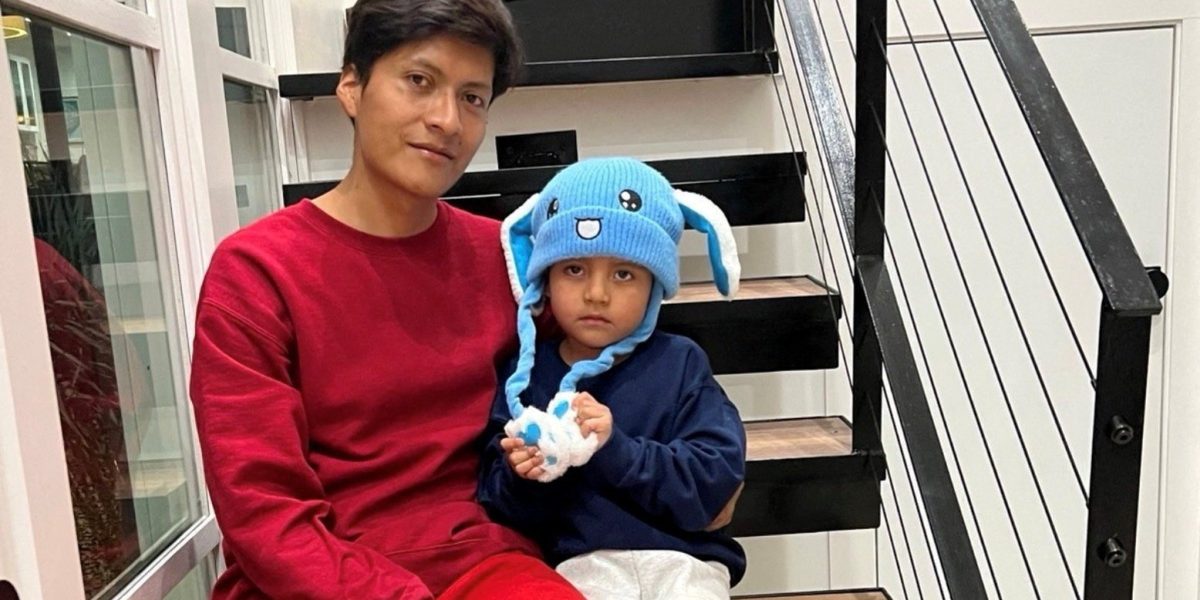 Liam Conejo Ramos, right, and his father Adrian Alexander Conejo Arias, who were detained by immigration officers in Minnesota and then taken to a detention center in Texas, sit on the stairs back at their home after a judge ordered their release, in Columbia Heights, Minnesota, in this picture obtained from social media Feb. 1, 2026. (OSV News/Joaquin Castro via BlueSky, via Reuters)