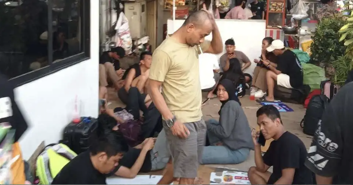 Desperate victims of scam center abuse wait for help outside the Indonesian embassy in Phnom Penh, Cambodia. (Terry Friel/Cambodia)