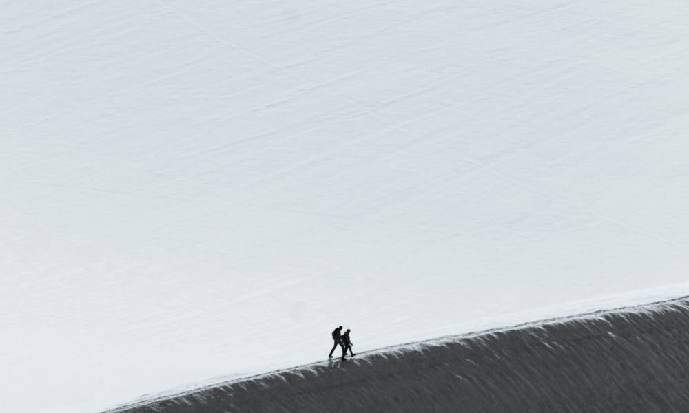 Two people climb a mountain. (Available in the public domain via Unsplash)