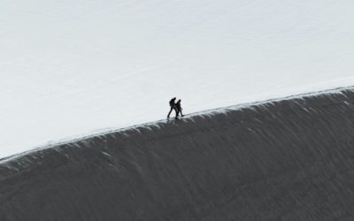 Two people climb a mountain. (Available in the public domain via Unsplash)