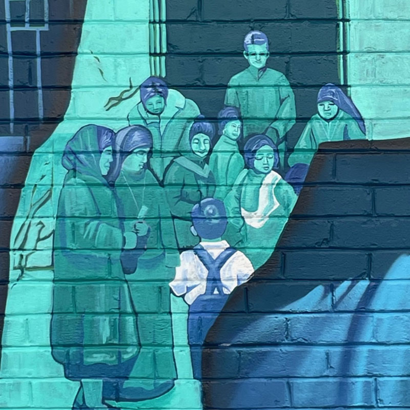 A scene in the mural “The Spirit of Our Roots” depicts Maryknoll Father Hugh Lavery and Maryknoll Sisters Mary Bernadette Yoshimochi and Susanna Hayashi offering pastoral care at the Manzanar internment camp. (Joseph Donovan/U.S.)