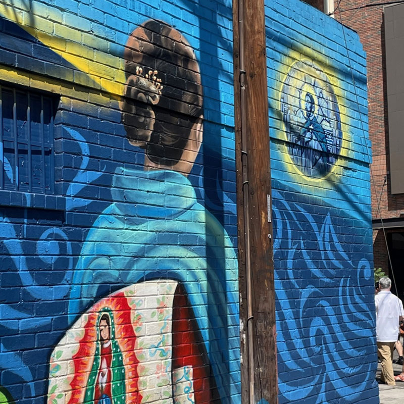 In the mural, artist Erin Yoshi painted a Japanese woman facing a portrait of St. Francis Xavier, patron of missions, for whom the chapel in Little Tokyo is named. The Virgin of Guadalupe is depicted on the woman’s traditional garment as an acknowledgment that the neighborhood is now predominantly Latino. (Joseph Donovan/U.S.)