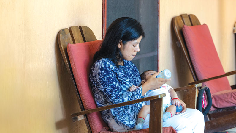 A young mother and her baby find a home at Hospicio Santa María, a home for HIV-positive and AIDS patients run by a Maryknoll sister and three Maryknoll affiliates. The hospice grounds include organic orchards and gardens, as well as an aviary. Located in the town of Pajapita in the department (state) of San Marcos, Guatemala, the property also houses the administrative offices of Project Life, an advocacy and educational organization that combats HIV/AIDS. (Octavio Durán/Guatemala)