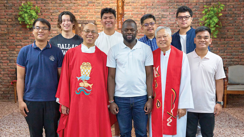 Maryknoll Fathers Joyalito Tajonera and Nhuan Nguyen (in vestments, left, right) train candidates such as Maryknoll Seminarians Josephat Odundo (center), Guilervan Omnes (back row, second from right) and Jethro Natividad (back row, far right) for a lifetime in mission. (Paul Jeffrey/Taiwan)