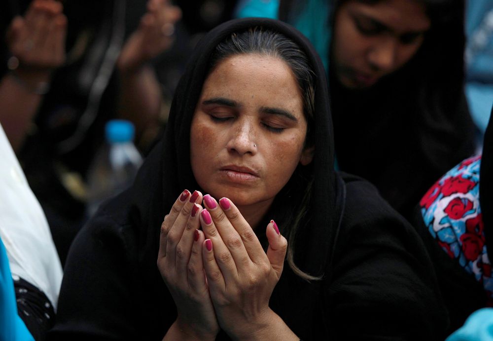 A Pakistani Christian woman prays during a Good Friday service at St. Anthony Church in Lahore. (CNS/Mohsin Raza, Reuters)