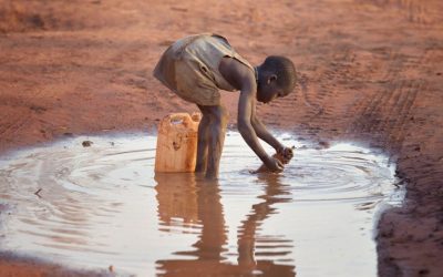 A girl fills a container with muddy water at the Ajuong Thok Refugee Camp in South Sudan, which hosts tens of thousands of displaced people from the Nuba Mountains of neighboring Sudan. (Paul Jeffrey/South Sudan)