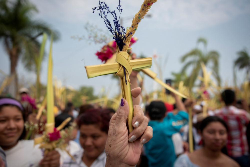 People raise their palm fronds for blessings during a Palm Sunday Mass March 24, 2024, in Managua, Nicaragua. (OSV News/Maynor Valenzuela, Reuters)
