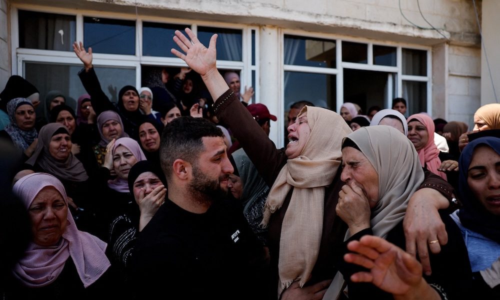 Mourners react during the funeral of Palestinian youths who were killed during an attack by Israeli settlers in Kafr Malik, in the Israeli-occupied West Bank, June 26, 2025. (OSV News photo/Ammar Awad, Reuters)