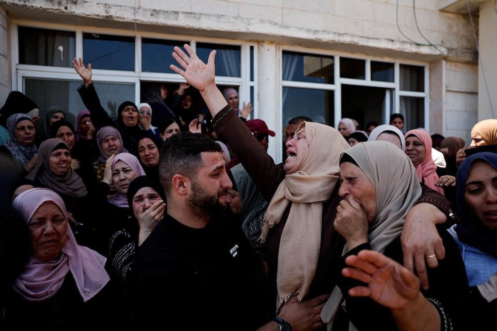 Mourners react during the funeral of Palestinian youths who were killed during an attack by Israeli settlers in Kafr Malik, in the Israeli-occupied West Bank, June 26, 2025. (OSV News photo/Ammar Awad, Reuters)