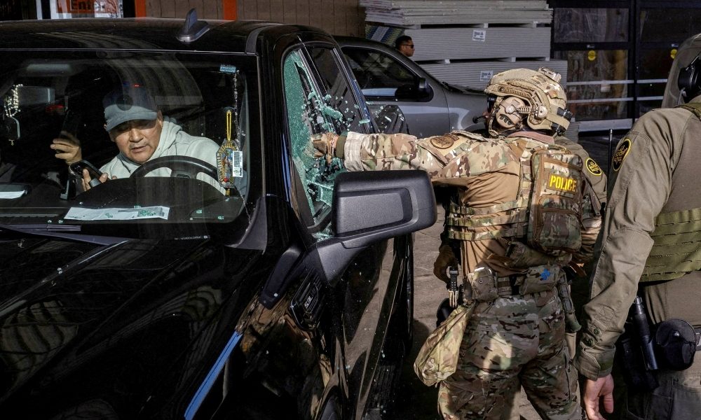 A U.S. federal agent smashes a car window while trying to detain a man during an immigration raid in Chicago, Dec. 17, 2025. An image of Mary and the Christ Child can be seen in the driver’s window. On Feb. 20, 2026, Bishop Brendan J. Cahill, chair of the U.S. Catholic bishops’ Committee on Migration, condemned the Trump administration’s plan for acquiring eight mega-detention centers for mass detention of immigrants, including families, it wants to deport. (OSV News/Jim Vondruska, Reuters)