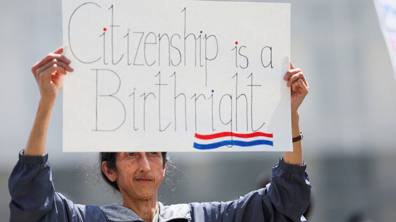 A demonstrator holds a placard during a protest outside the Supreme Court May 15, 2025, as the justices heard oral arguments in Trump v. CASA related to lower courts placing an injunction on Trump’s executive order of Jan. 20, 2025, to end birthright citizenship. In a 6-3 ruling, the Supreme Court June 27 limited the scope of federal courts to block presidential policies nationwide. On April 1, 2026, the court will hear oral arguments in Trump v. Barbara, a challenge to the order ending birthright citizenship. (OSV News/Leah Millis, Reuters)