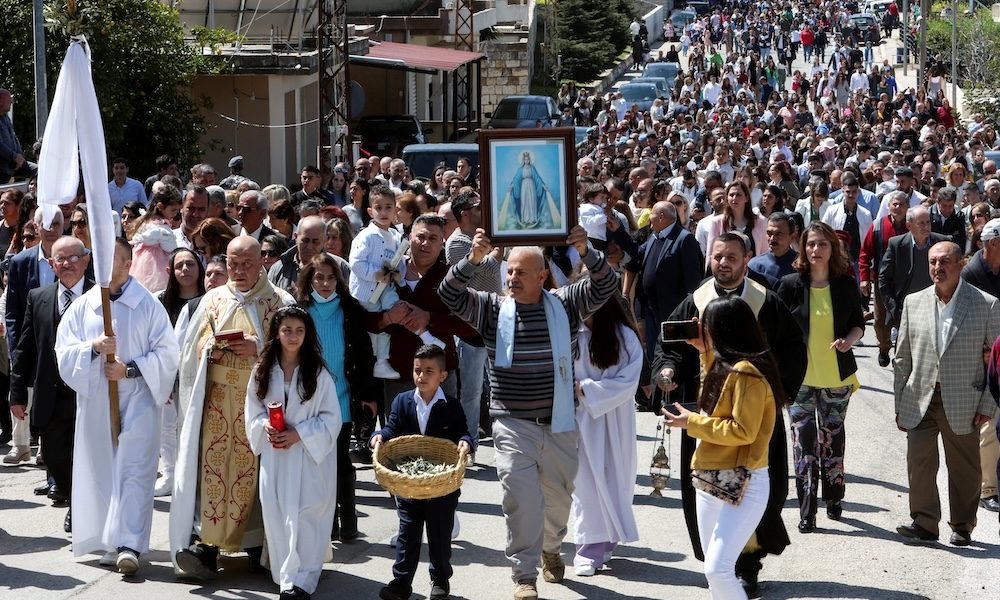 Lebanese Maronite Catholic priest Father Pierre al-Rahi, also known by his French name Pierre el-Raï, in vestments second from left, takes part in a Palm Sunday procession in Qlayaa, Lebanon, April 2, 2023. Father al-Rahi was killed in this village in southern Lebanon during an Israeli artillery tank fire on a house March 9, 2026. (OSV News photo/Aziz Taher, Reuters)