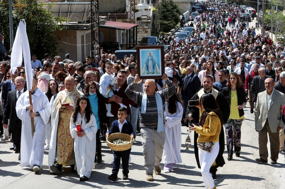 Lebanese Maronite Catholic priest Father Pierre al-Rahi, also known by his French name Pierre el-Raï, in vestments second from left, takes part in a Palm Sunday procession in Qlayaa, Lebanon, April 2, 2023. Father al-Rahi was killed in this village in southern Lebanon during an Israeli artillery tank fire on a house March 9, 2026. (OSV News photo/Aziz Taher, Reuters)