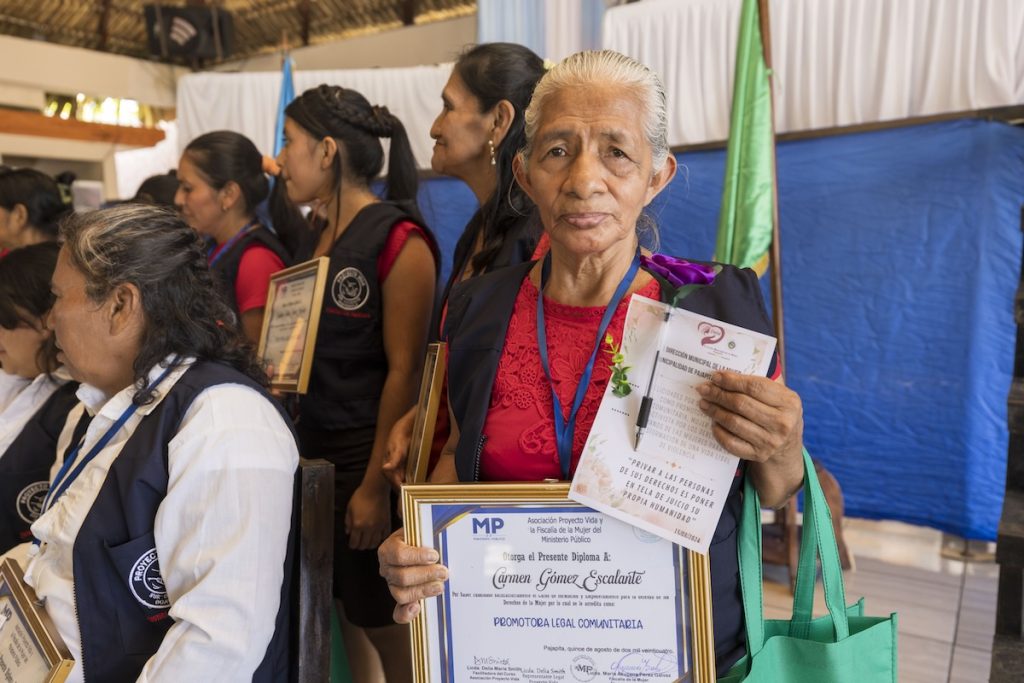 A new community legal promoter from the second cohort proudly shows her diploma. Many women in the training program run by Maryknoll Sister Delia “Dee” Smith have not had opportunities for formal schooling. (Octavio Durán/Guatemala)