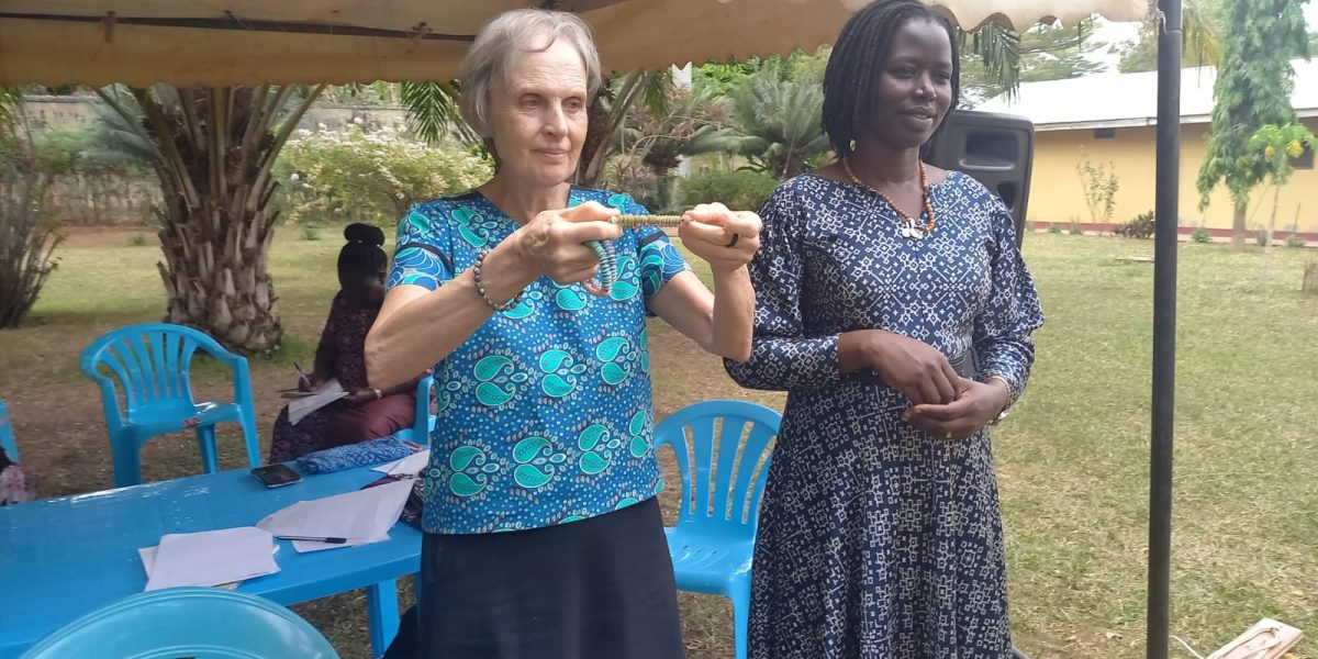 Maryknoll Lay Missioner Joanne Blaney (left) teaches a course in trauma healing and nonviolent conflict resolution in Northern Uganda. She is joined by local leader Immaculate Adong (right), who was 8 when her father was killed in the 1995 Atiak massacre, and who now manages a women’s cooperative while also raising her five sons. (Courtesy of Joanne Blaney/Maryknoll Lay Missioners/Uganda)