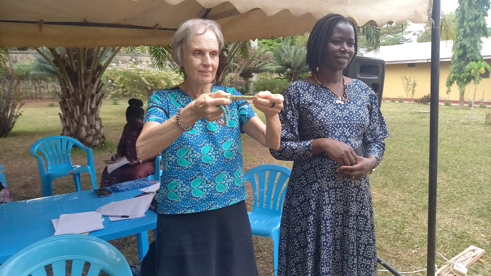 Maryknoll Lay Missioner Joanne Blaney (left) teaches a course in trauma healing and nonviolent conflict resolution in Northern Uganda. She is joined by local leader Immaculate Adong (right), who was 8 when her father was killed in the 1995 Atiak massacre, and who now manages a women’s cooperative while also raising her five sons. (Courtesy of Joanne Blaney/Maryknoll Lay Missioners/Uganda)