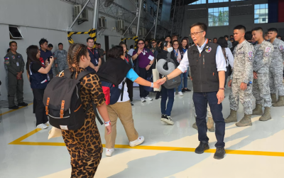 Hans Leo Cacdac, the secretary of the Department of Migrant Workers in the Philippines, welcomes Filipino migrant workers who were stranded in the United Arab Emirates and are back in the Philippines aboard the sixth government-chartered flight that landed at Villamor Air Base in Pasay City on March 29, 2026. (Courtesy of Department of Migrant Workers/Philippines)