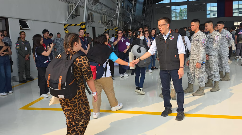 Hans Leo Cacdac, the secretary of the Department of Migrant Workers in the Philippines, welcomes Filipino migrant workers who were stranded in the United Arab Emirates and are back in the Philippines aboard the sixth government-chartered flight that landed at Villamor Air Base in Pasay City on March 29, 2026. (Courtesy of Department of Migrant Workers/Philippines)