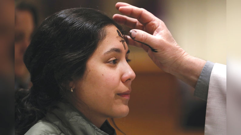 A young woman receives ashes during Ash Wednesday at Sacred Heart Church in Prescott, Arizona, as the season of Lent begins. (OSV News/Bob Roller/U.S.)