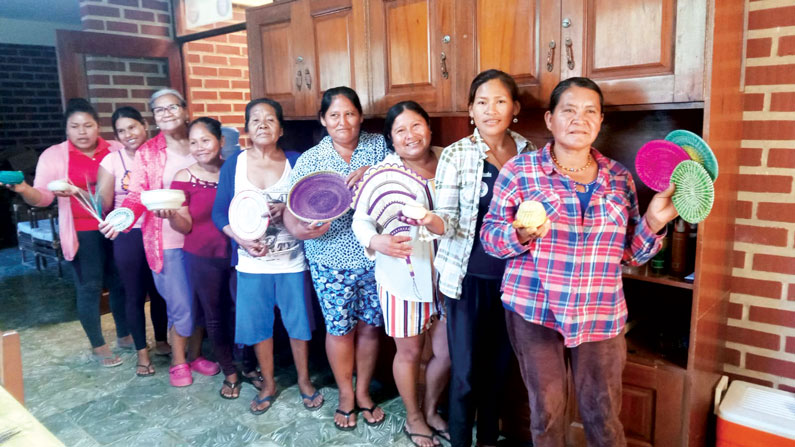 The Mojeño-Trinitarian women artisans of the Santísima Trinidad community in the Bolivian Amazon display their basketry pieces, which they sell to support their families. (Alejandro Marina/Bolivia)