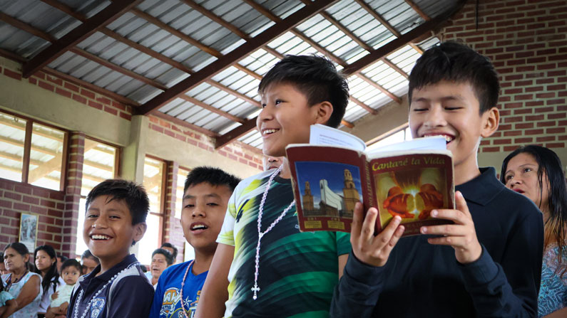 Children from the TIPNIS Indigenous community in the Bolivian Amazon sing joyfully during a Mass in the church of Santísima Trinidad, where Maryknoll missioners have served for several years and have recently been given pastoral responsibility for the parish.