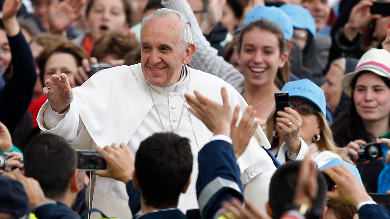 Pope Francis greets cheering crowds at St. Peter’s Square in 2013, the year he was elected. Formerly known as Jorge Mario Bergoglio, the Jesuit served previously as archbishop of Buenos Aires, Argentina. (CNS/Paul Haring/Vatican City)