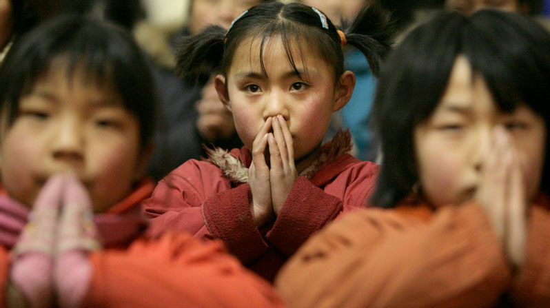 Children are pictured in a file photo praying during Mass at a Catholic church in a village at the outskirts of Taiyuan, China. Children “bear the brunt” of international religious freedom violations, panelists at an April 30, 2026, hearing of the U.S. Commission on International Religious Freedom said. (OSV News/Reinhard Krause, Reuters)