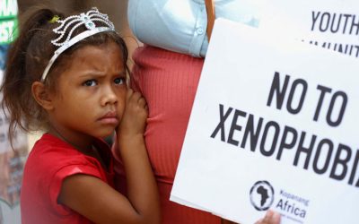 A child looks on next to her mother, who is holding a placard, during a protest march by members of a South African anti-xenophobia organization in Johannesburg March 26, 2022. The march followed a campaign by another group that called on the government to prioritize jobs for nationals and remove immigrants who are in the country without authorization. (OSV News/Siphiwe Sibeko, Reuters)
