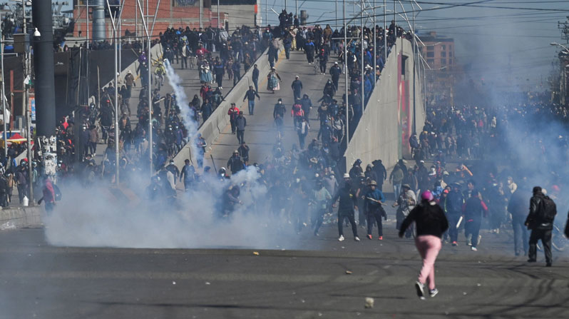 Protesters run past tear gas as they demonstrate against President Rodrigo Paz’s government amid an ongoing economic and fuel crisis in El Alto, Bolivia, May 16, 2026. (OSV News/Claudia Morales, Reuters)