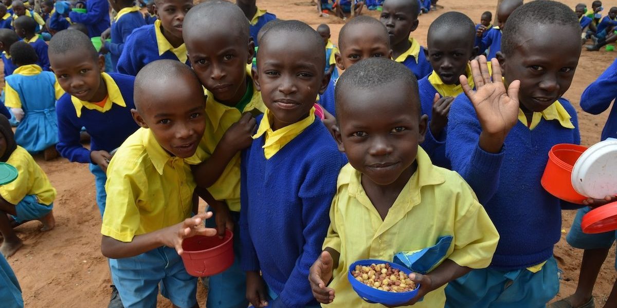 Students enjoy a healthy meal at King’utheni Primary School in the drought-affected area of Kibwezi in southeast Kenya, where Maryknoll funds several relief projects. (Moses Njagua Gitahi/Kenya)