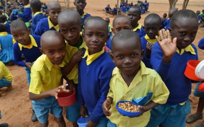 Students enjoy a healthy meal at King’utheni Primary School in the drought-affected area of Kibwezi in southeast Kenya, where Maryknoll funds several relief projects. (Moses Njagua Gitahi/Kenya)