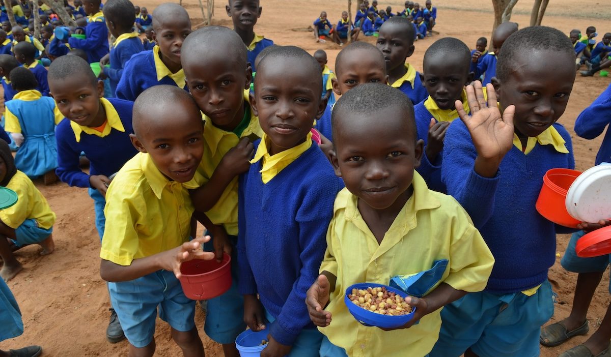 Students enjoy a healthy meal at King’utheni Primary School in the drought-affected area of Kibwezi in southeast Kenya, where Maryknoll funds several relief projects. (Moses Njagua Gitahi/Kenya)