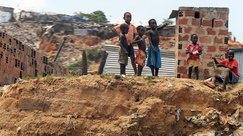 Children stand on a pile of refuse in Luanda, Angola. (CNS/Alessia Giuliani, Catholic Press Photo)