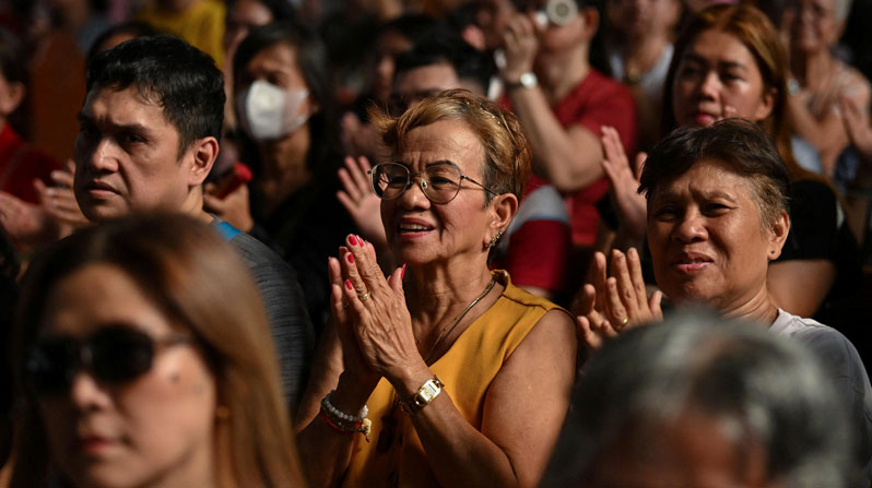 Filipino Catholics attend a Mass at Quiapo Church in Manila May 9, 2025, a day after the election of Pope Leo XIV at the Vatican. The Philippines, where Maryknoll missioners have served for more than a century, is one of a number of countries adversely affected by artificial intelligence, the focus of Pope Leo’s first encyclical, Magnifica Humanitas. (OSV News/Noel Celis, Reuters)