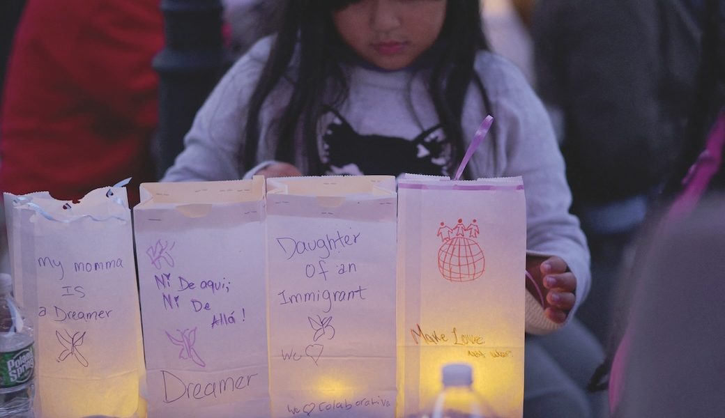 An 8-year-old girl arranges luminaries with messages about her mother, a DACA “dreamer,” during a vigil in Chelsea, Massachusetts, a community affected by raids and detentions by Immigration and Customs Enforcement. (OSV News/Brian Snyder/Reuters/U.S.)