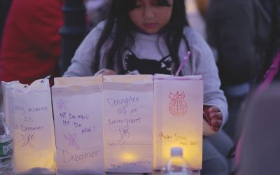 An 8-year-old girl arranges luminaries with messages about her mother, a DACA “dreamer,” during a vigil in Chelsea, Massachusetts, a community affected by raids and detentions by Immigration and Customs Enforcement. (OSV News/Brian Snyder/Reuters/U.S.)