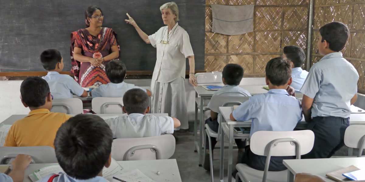 Pointing to the blackboard, Maryknoll Sister Miriam Francis Perlewitz engages with students at BACHA, an English medium school she cofounded in a neighborhood of Dhaka, Bangladesh. (Sean Sprague/Bangladesh)