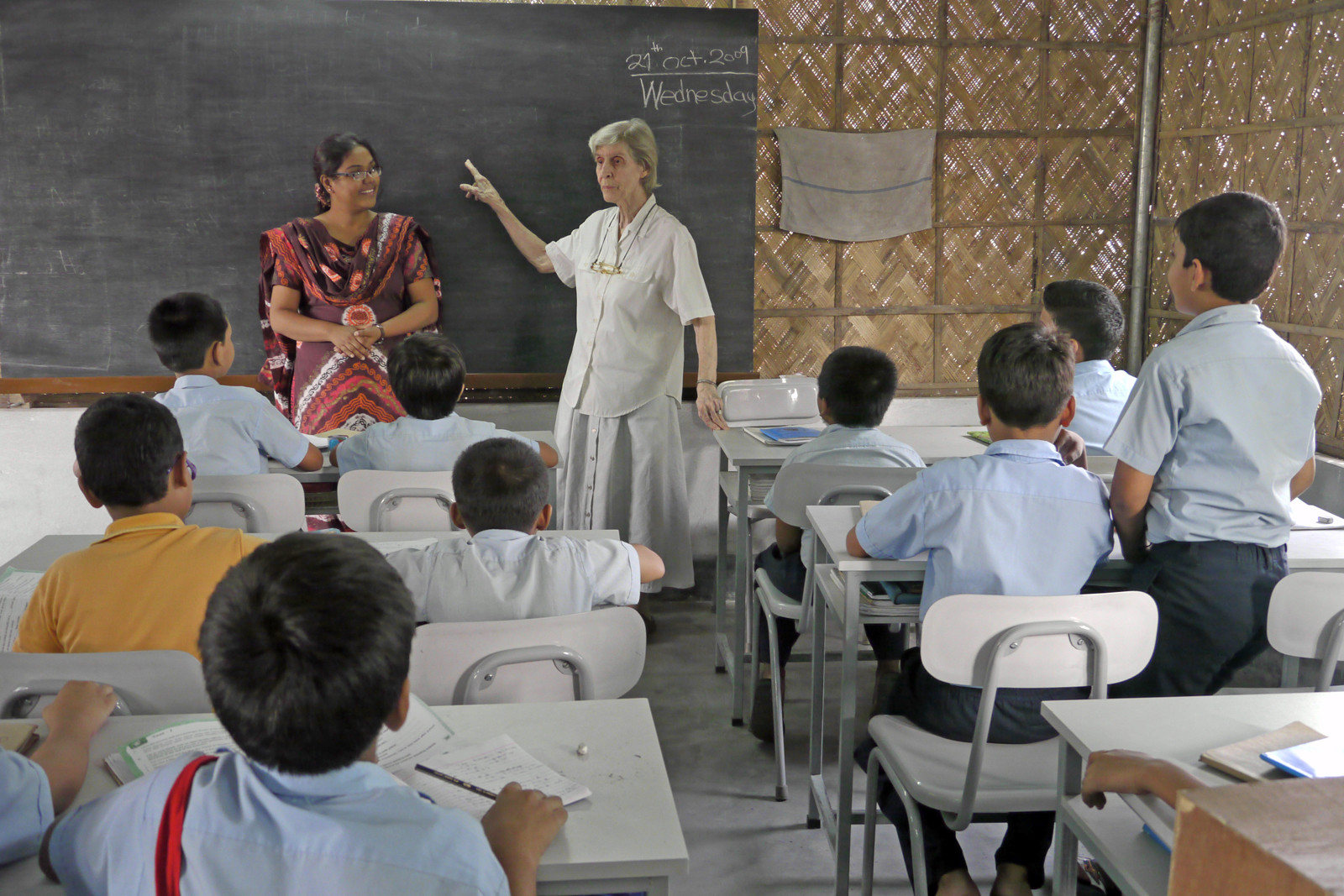 Pointing to the blackboard, Maryknoll Sister Miriam Francis Perlewitz engages with students at BACHA, an English medium school she cofounded in a neighborhood of Dhaka, Bangladesh. (Sean Sprague/Bangladesh)