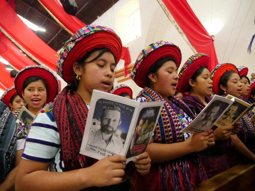 Tz’utujil women sing during the Mass celebrating Father Rother’s beatification, recalling the priest’s words, “The shepherd cannot run at the first sign of danger,” a statement that reflects his unwavering commitment to his people during one of Guatemala’s darkest history. (Sean Sprague/Guatemala)