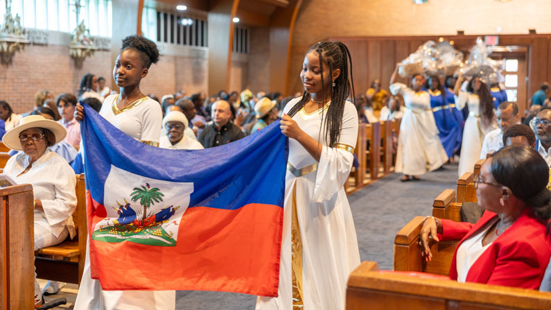 Carrying the flag of Haiti and baskets with fruits and vegetables that are grown in the country, girls and young women lead an offertory procession during a Mass on June 28, 2026, for the feast day of Our Lady of Perpetual Help, patroness of Haiti, at Our Lady of Sorrows Church in Takoma Park, Maryland. The service was celebrated for the Haitian Catholic community of Washington. (OSV News/Mihoko Owada, Catholic Standard)
