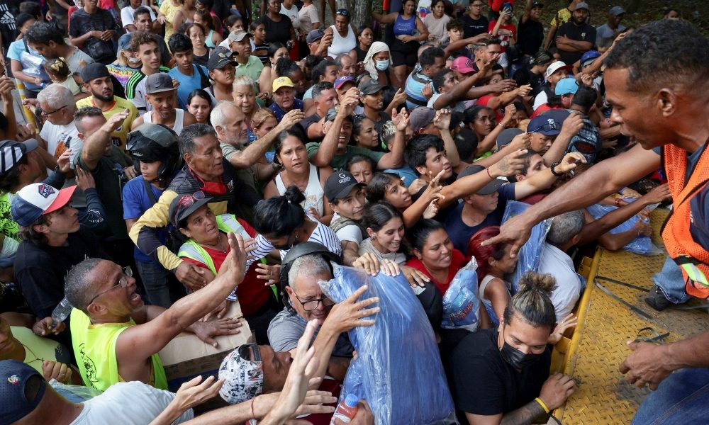 People receive humanitarian aid in Tanaguarena, Venezuela, July 14, 2026, following the aftermath of the June 24 earthquakes. The demand for help comes as the United Nations launched an appeal for roughly $300 million to assist 1.3 million people in urgent need of aid in the South American country where nongovernmental organizations until recently were targets of government repression. (OSV News/Gaby Oraa, Reuters)