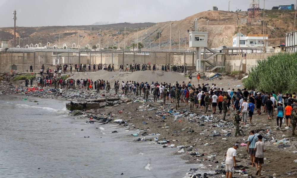 People in Ceuta, Spain, walk toward the border with Morocco as they leave Spanish territory on July 31, 2026, amid massive crossings of migrants — on foot and by sea — from Morocco into Spanish territory. The Diocese of Cádiz and Ceuta provided emergency resources to civil authorities on July 31, when more than 60,000 migrants crossed from Morocco into the Spanish enclave of Ceuta, overwhelming local infrastructure. (OSV News/Jon Nazca, Reuters)