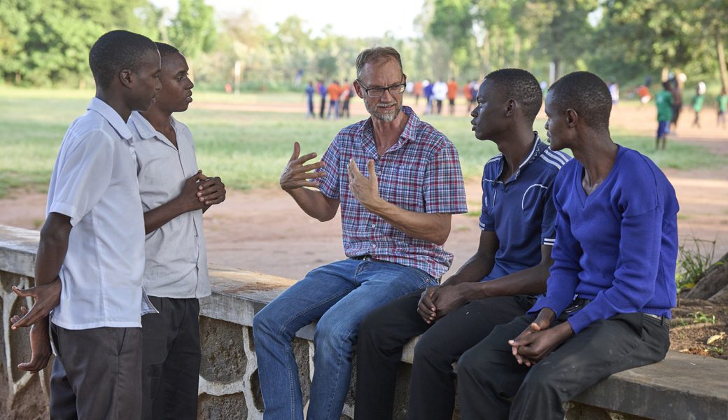 Steve Veryser engages with deaf students at Bwiru Boys Technical School in Mwanza, Tanzania, where he teaches mathematics. He also manages the Lake House of Prayer, a contemplative retreat center on the shores of Lake Victoria.​ (Paul Jeffrey/Tanzania)