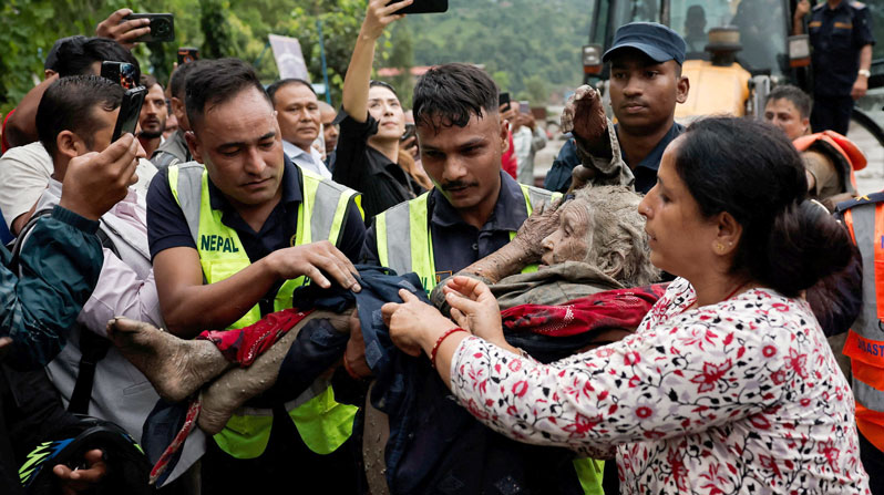 Police officers carry an elderly survivor to a safer place at Trishuli in Nepal’s Nuwakot district Aug. 27, 2026, following devastating floods. Massive flash floods in a border area of Nepal and China killed at least 160 people and left hundreds of tourists, workers and others missing after suddenly sweeping through communities and halting travel in some areas Aug. 26. Experts said a glacial collapse caused the disaster in the warming Himalayan region. (OSV News/Navesh Chitrakar, Reuters)