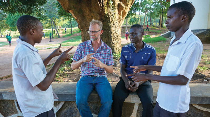 Using sign language, Maryknoll Lay Missioner Stephen Veryser tutors deaf students in math at Bwiru Boys Technical School, where he first served with the Peace Corps. (Paul Jeffrey/Tanzania