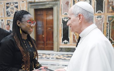 Joy Buolamwini, a computer scientist, presents a copy of her book to the pope at a Vatican conference on artificial intelligence Nov. 13, 2025. (CNS/Vatican Media/Vatican City)