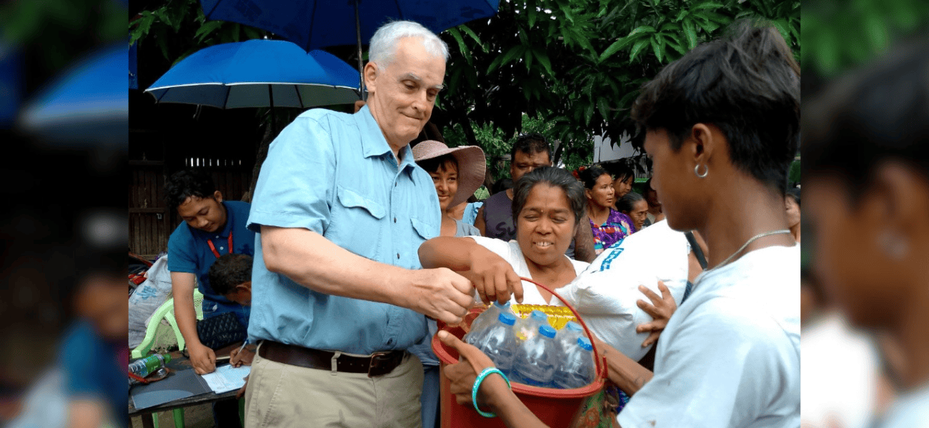 El Padre Maryknoll John Barth distribuye comida y agua a sobrevivientes de un terremoto en Myanmar a inicios de este año. A través de la Diócesis de Mandalay en Myanmar, el Padre Barth gestionó los fondos recolectados por la Sociedad Maryknoll para llevar ayuda a los necesitados. (Cortesía de John Barth/Myanmar)